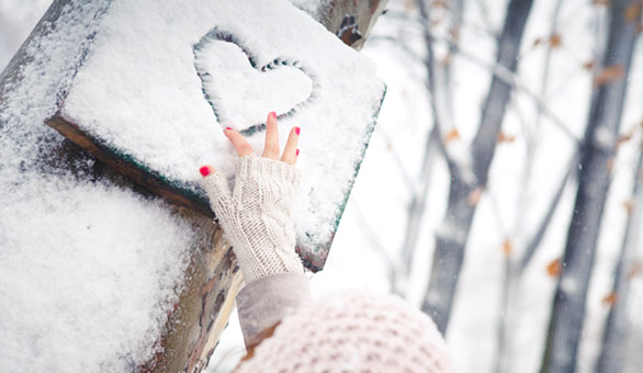 Woman Drawing Heart Into Snow