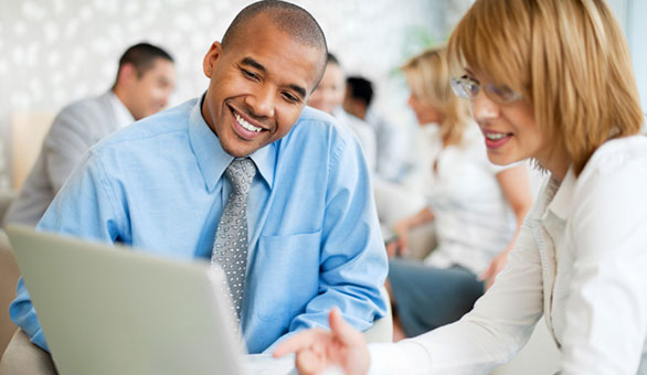 Woman and Man Working with a Laptop