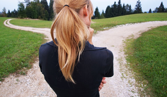 Woman thinking at a fork in the road