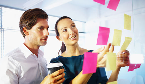 Man and Woman Brainstorming with Sticky Notes